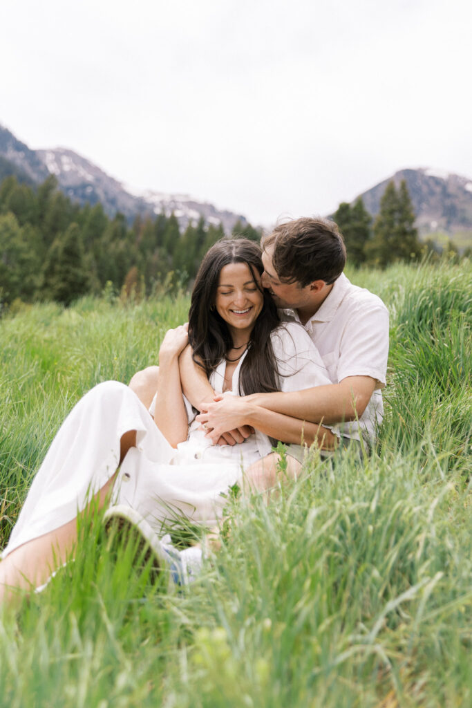 Couple in white, spring clothing in grass