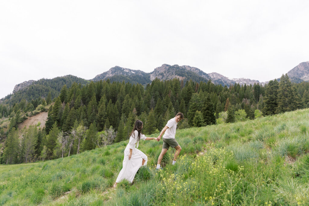 Utah Tibble Fork Reservoir engagement session couple walking on hill