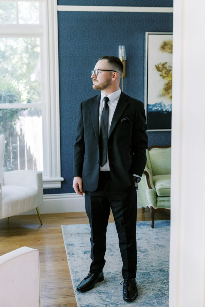 Groom adjusting tie before wedding at La Réve Estate in Elk Grove

