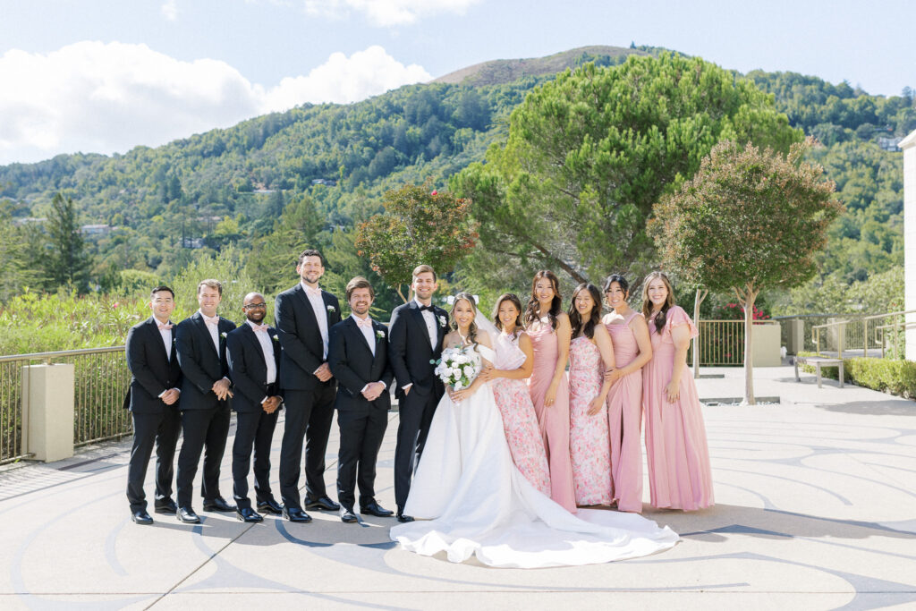 Mix and match bridesmaid dresses in pink and floral tones at University Redlands Marin wedding