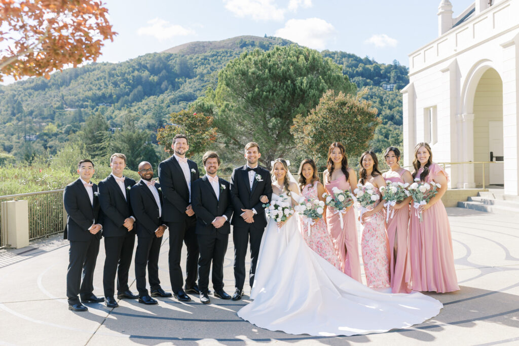 Mix and match bridesmaid dresses in pink and floral tones at University Redlands Marin wedding