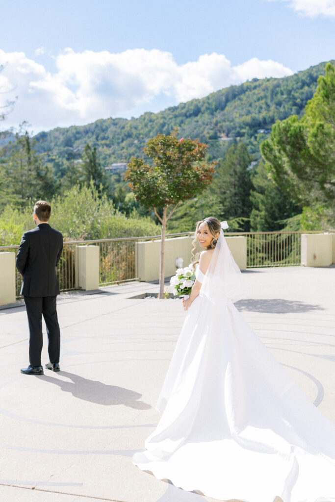 Bride and groom sharing a joyful moment in front of the chapel at University Redlands Marin