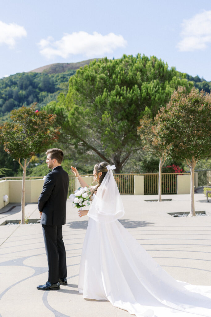 Bride and groom sharing a joyful moment in front of the chapel at University Redlands Marin