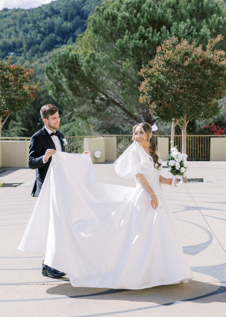 Bride and groom sharing a joyful moment in front of the chapel at University Redlands Marin