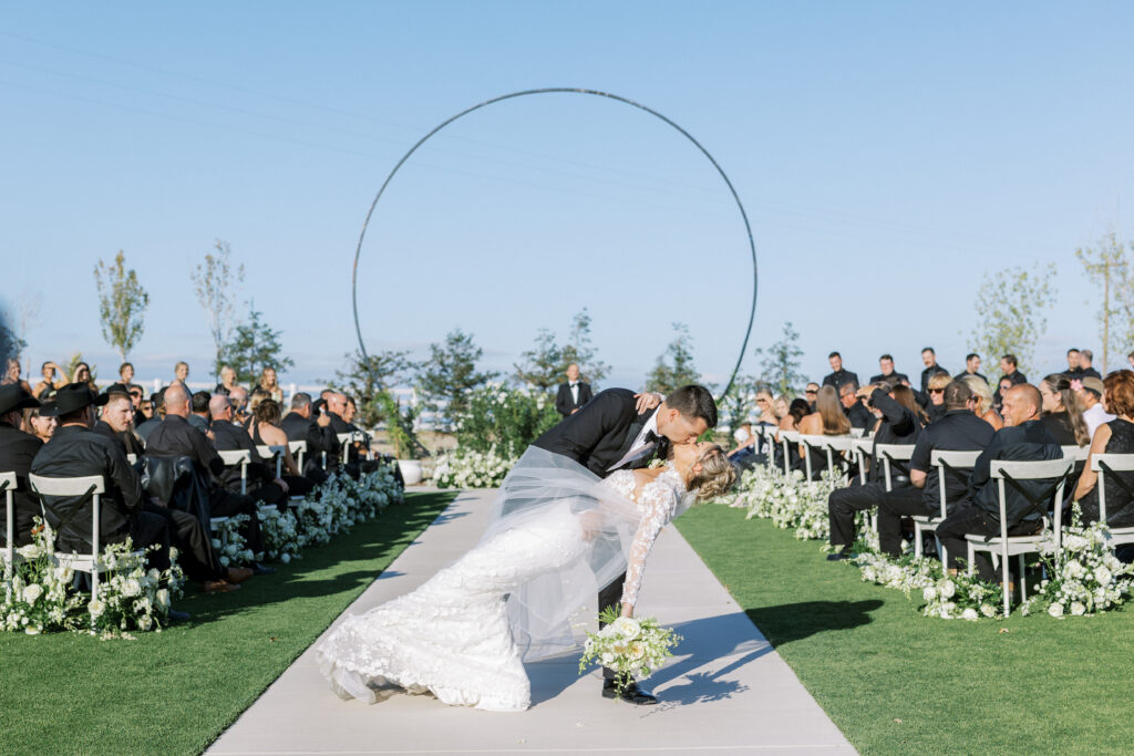 Bride and groom share a kiss during their luxury wedding at The Margaux in Madera, captured by Fresno wedding photographer Shannon Bryn Photo