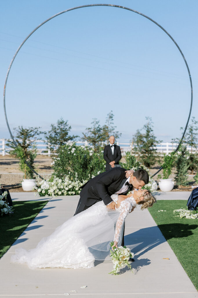 Bride and groom share a kiss during their luxury wedding at The Margaux in Madera, captured by Fresno wedding photographer Shannon Bryn Photo