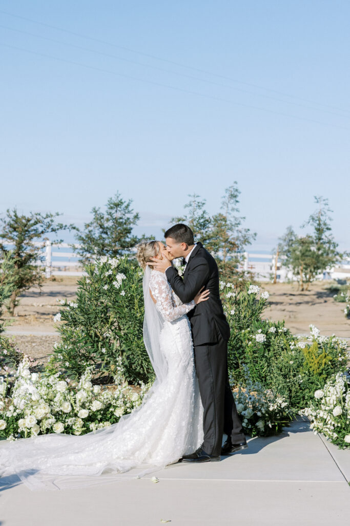Bride and groom share a kiss during their luxury wedding at The Margaux in Madera, captured by Fresno wedding photographer Shannon Bryn Photo