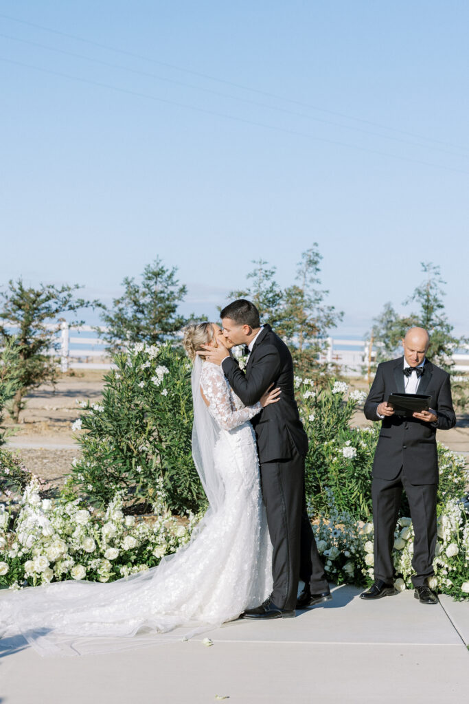 Bride and groom share a kiss during their luxury wedding at The Margaux in Madera, captured by Fresno wedding photographer Shannon Bryn Photo