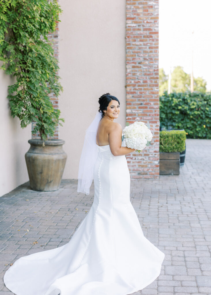 Bride in strapless Stella York gown with chic updo at The Palm Event Center in Livermore