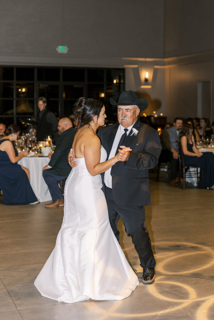 Elegant candle chandelier over monogram dance floor at The Palm Livermore wedding