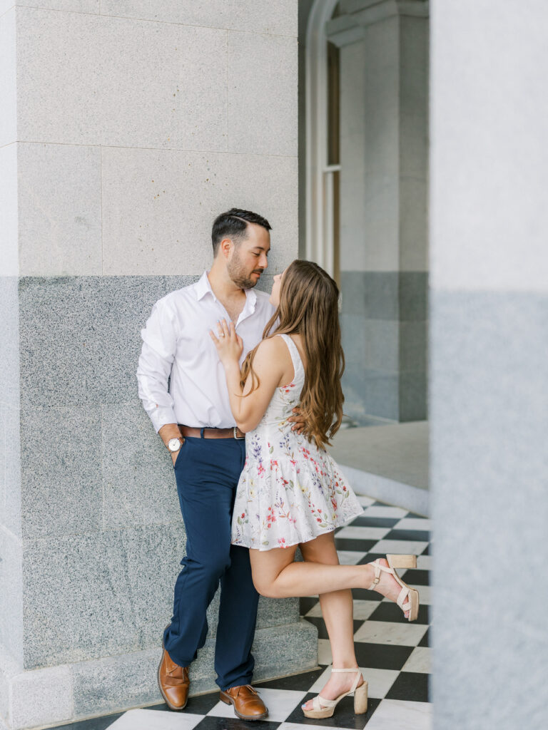 Couple embracing in front of the California State Capitol during their Sacramento engagement session
