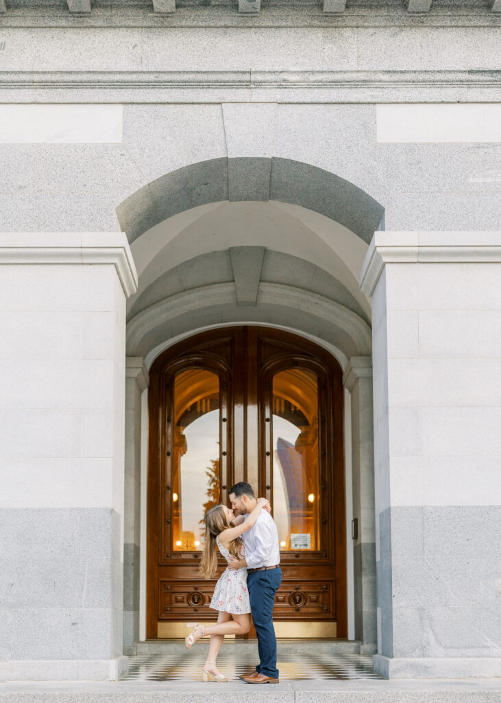 Couple embracing in front of the California State Capitol during their Sacramento engagement session