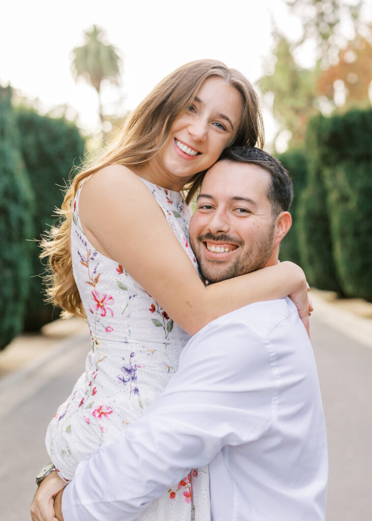 Couple embracing in front of the California State Capitol during their Sacramento engagement session