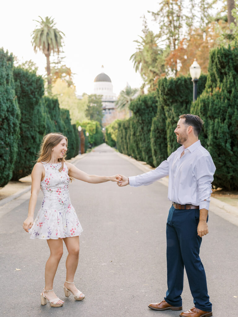 Couple embracing in front of the California State Capitol during their Sacramento engagement session