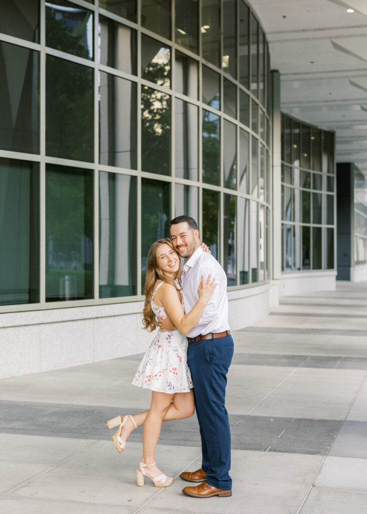 Couple embracing in front of the California State Capitol during their Sacramento engagement session