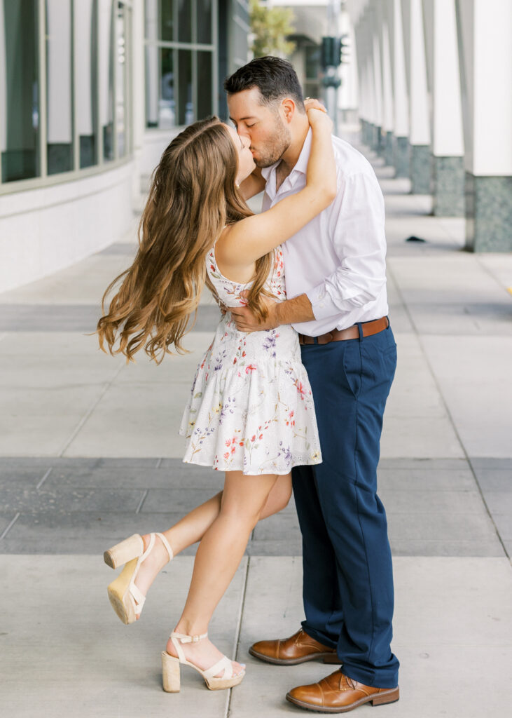 Couple embracing in front of the California State Capitol during their Sacramento engagement session