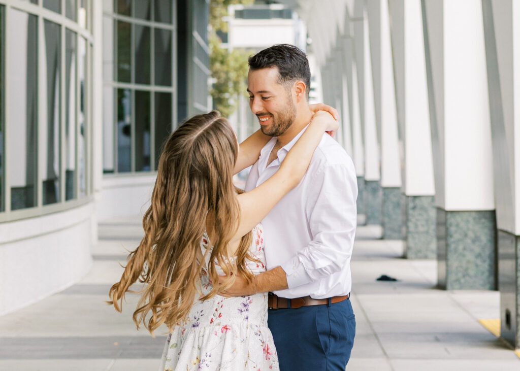 Couple embracing in front of the California State Capitol during their Sacramento engagement session