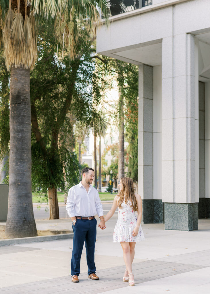 Couple embracing in front of the California State Capitol during their Sacramento engagement session