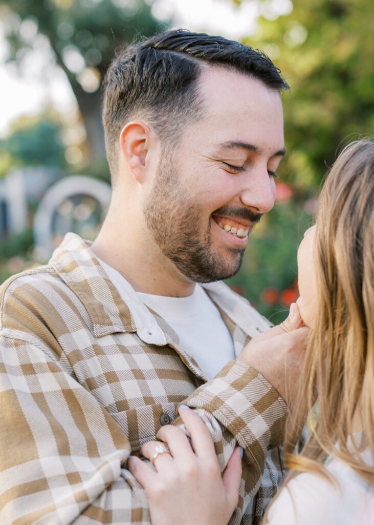 Couple walking hand in hand through the Capitol Rose Garden during their Sacramento engagement session