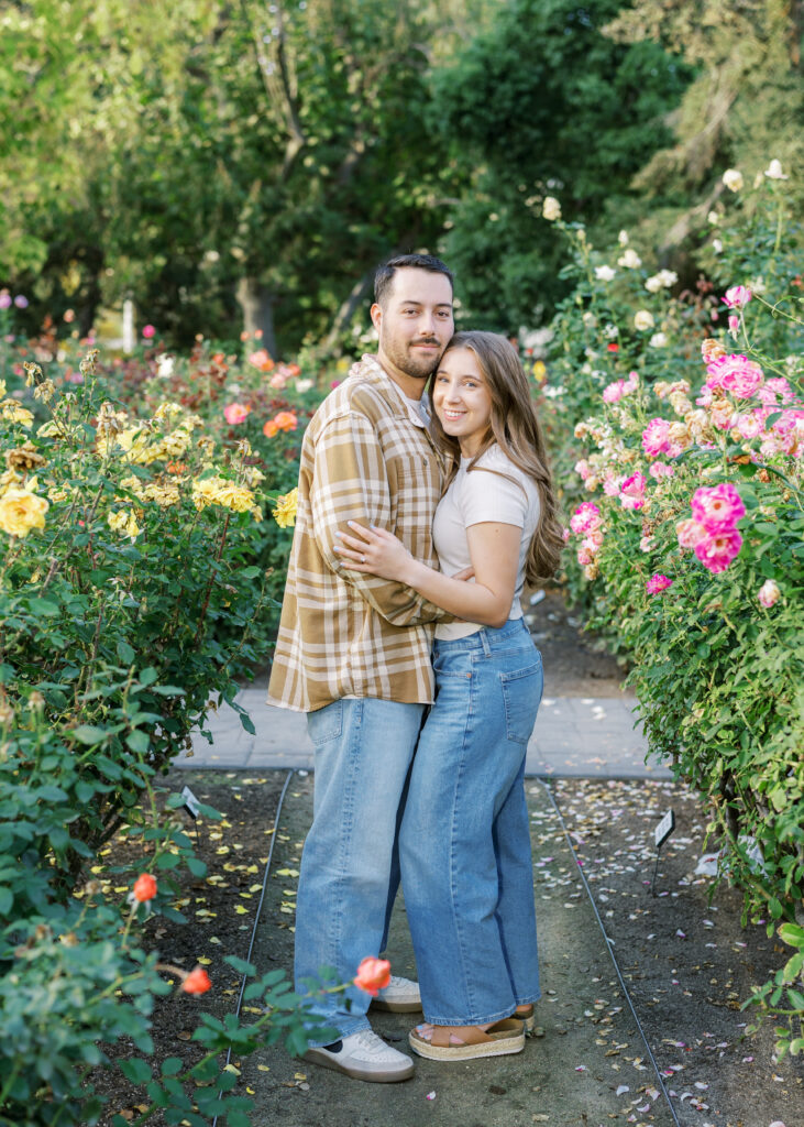 Couple walking hand in hand through the Capitol Rose Garden during their Sacramento engagement session