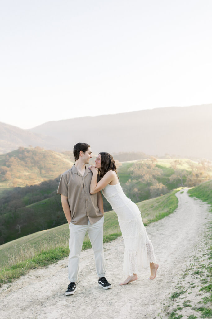Natural engagement photography in Livermore California with rolling hills and golden hour light