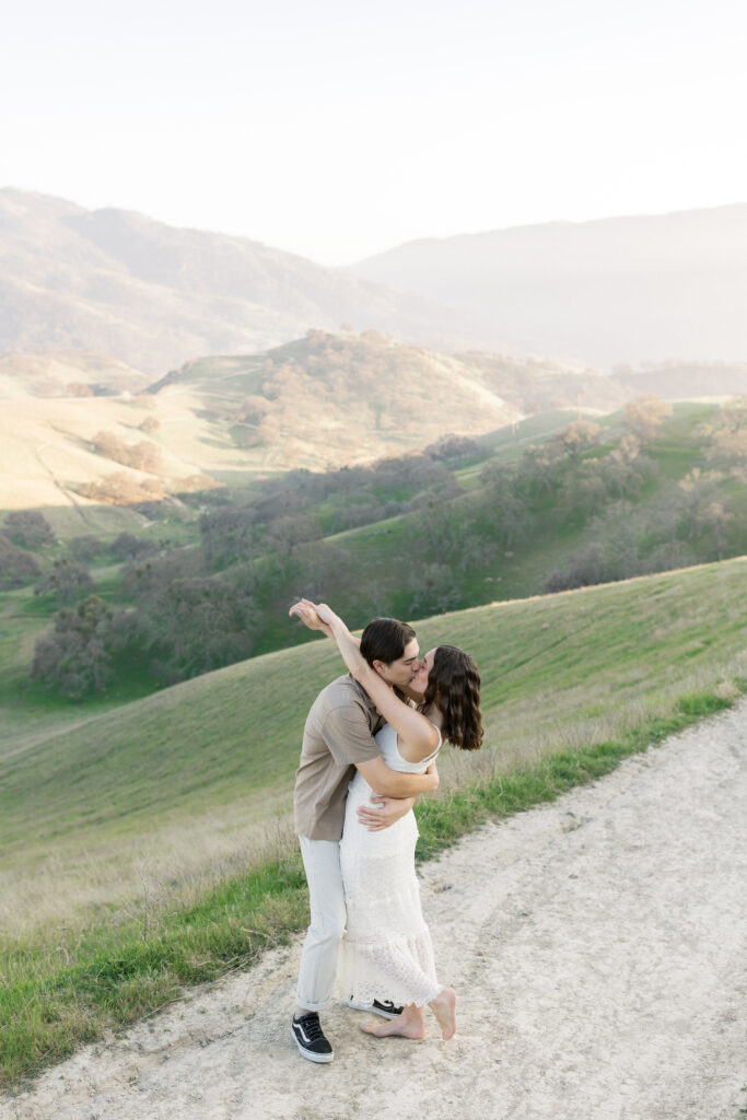 Natural engagement photography in Livermore California with rolling hills and golden hour light