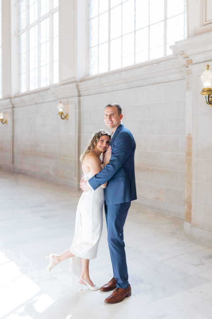 Couple on the fourth floor of the San Francisco City Hall Building for engagement photos