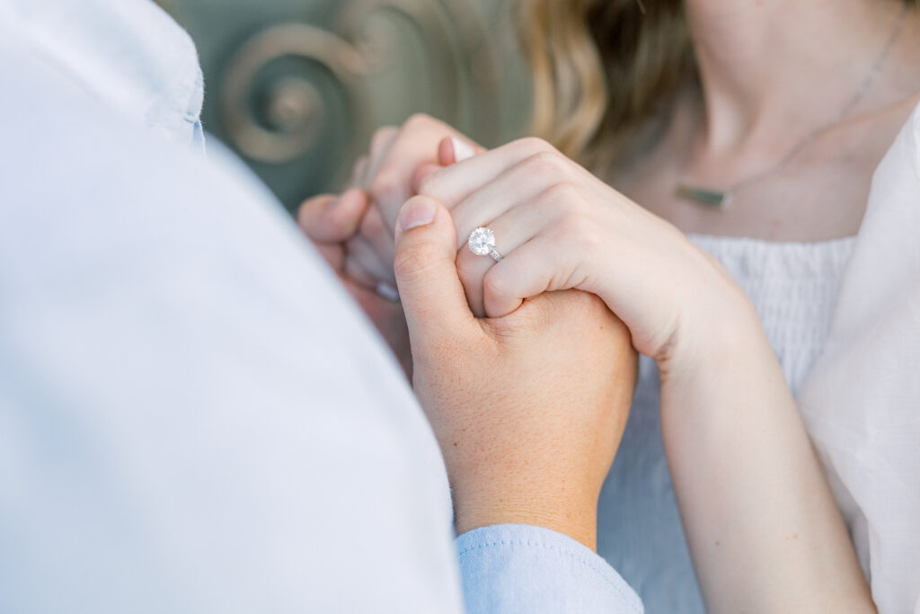 Refined and natural engagement photo of couple close together with engagement ring