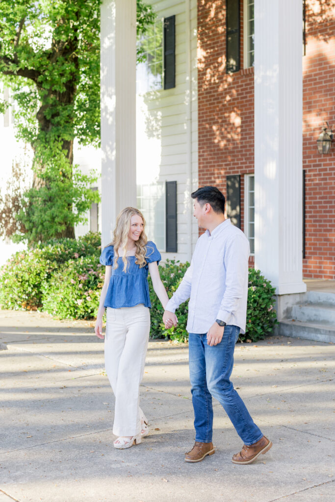 Couple walking hand in hand during natural engagement session